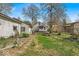 A backyard featuring a grassy area, picnic table, and detached building at 7016 Evanston Ave, Indianapolis, IN 46220