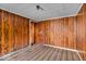 A view of a bedroom showcasing wood paneling, a window, and unique carpeting at 7016 Evanston Ave, Indianapolis, IN 46220