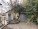 Detached garage with brick-paved driveway and mature trees and greenery at 7016 Evanston Ave, Indianapolis, IN 46220