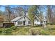 Quaint, charming single Gathering home on a grassy lot with mature trees surrounding the property at 7016 Evanston Ave, Indianapolis, IN 46220