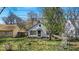 Charming home featuring a cozy front porch and mature trees in the front yard at 7016 Evanston Ave, Indianapolis, IN 46220