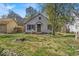 Charming home featuring a cozy front porch and mature trees in the front yard at 7016 Evanston Ave, Indianapolis, IN 46220