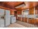 Functional kitchen features wood cabinets, tile flooring, and a complete appliance set for cooking at 7016 Evanston Ave, Indianapolis, IN 46220