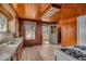 Well-used kitchen features classic wood accents, durable tile flooring, and practical layout at 7016 Evanston Ave, Indianapolis, IN 46220