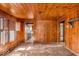 Spacious living room with wood paneling, vintage floors, and large windows with natural light at 7016 Evanston Ave, Indianapolis, IN 46220