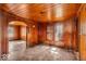 Inviting living room featuring classic wood paneling, vintage flooring, and ample natural light from the windows at 7016 Evanston Ave, Indianapolis, IN 46220