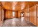 Bright living room features classic wood paneling, vintage flooring, and arched doorway to other rooms at 7016 Evanston Ave, Indianapolis, IN 46220
