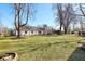 Expansive backyard with mature trees surrounding the perimeter and a well manicured lawn at 7844 N Audubon Rd, Indianapolis, IN 46250