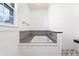 Elegant bathtub with gray tile surround, shiplap walls and a window at 7844 N Audubon Rd, Indianapolis, IN 46250