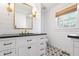 Modern bathroom with a vanity featuring a dark countertop and patterned floor tiles at 7844 N Audubon Rd, Indianapolis, IN 46250