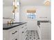 Stylish bathroom featuring a vanity with a black countertop and patterned floor tiles at 7844 N Audubon Rd, Indianapolis, IN 46250