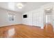 Bright bedroom with hardwood floors, one window, a modern light fixture and a closet at 7844 N Audubon Rd, Indianapolis, IN 46250