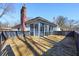 The home's wooden deck, screened-in back porch, and tree-filled backyard at 7844 N Audubon Rd, Indianapolis, IN 46250