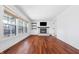 Bright Living Room boasts dark hardwood floors, large windows, white walls, and cozy fireplace at 7844 N Audubon Rd, Indianapolis, IN 46250