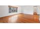 Cozy room with wood floors, white walls, and a window with lots of natural light at 7844 N Audubon Rd, Indianapolis, IN 46250