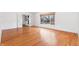 Living room with hardwood floors, white trim and French doors to a living room with fireplace at 7844 N Audubon Rd, Indianapolis, IN 46250