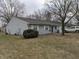 Charming single story home with light grey siding and inviting front yard at 8002 Bryan Dr, Indianapolis, IN 46227