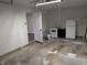 A peek into this garage shows the white walls, and appliances in the back corner at 8002 Bryan Dr, Indianapolis, IN 46227