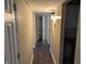 Hallway with pantry, new floor and updated light fixtures at 8002 Bryan Dr, Indianapolis, IN 46227