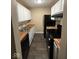 Galley kitchen featuring black appliances, white cabinets, and wood-style countertops at 8002 Bryan Dr, Indianapolis, IN 46227