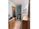 Bright and airy bathroom with a double vanity, light blue walls, and a door leading to another room at 804 N Jameson St, Lebanon, IN 46052