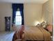 A serene bedroom featuring a large bed with neutral bedding, soft natural light, and simple, calming decor at 804 N Jameson St, Lebanon, IN 46052
