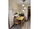Cozy dining area features a wooden table set for four, complemented by stylish lighting and neutral walls at 804 N Jameson St, Lebanon, IN 46052