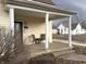 Inviting covered front porch with classic columns, seating, and a view of the surrounding neighborhood at 804 N Jameson St, Lebanon, IN 46052