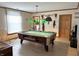 This game room features a classic pool table under vintage-style lighting, complemented by rustic wall decorations at 804 N Jameson St, Lebanon, IN 46052
