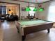The game room showcases a pool table with overhead lighting, adjoining the living area and promoting entertainment at 804 N Jameson St, Lebanon, IN 46052