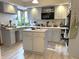 Well-lit kitchen boasts bright cabinets, stainless steel appliances, and a center island for added prep space at 804 N Jameson St, Lebanon, IN 46052