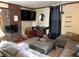 Inviting living room with a brick fireplace, gray sectional sofa, and musical instruments, perfect for relaxing or entertaining at 804 N Jameson St, Lebanon, IN 46052