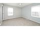 Bedroom with neutral paint and carpet and two windows for natural light at 8139 Laughlin Dr, Indianapolis, IN 46219