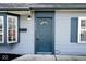 Close-up of the blue front door with sidelight windows and house number for easy identification at 8139 Laughlin Dr, Indianapolis, IN 46219