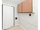 Laundry room with storage above the hookups and tile floor at 8139 Laughlin Dr, Indianapolis, IN 46219