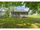 The backyard features a well-maintained lawn and a view of the home's exterior at 818 S Grant St, Muncie, IN 47302