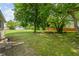 Large backyard with mature trees and lawn provides ample space for outdoor activities at 818 S Grant St, Muncie, IN 47302