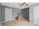 Bedroom featuring light wood floors, gray walls, and a ceiling fan at 818 S Grant St, Muncie, IN 47302