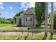Charming gray home featuring a classic design, a well-maintained lawn, and inviting curb appeal at 818 S Grant St, Muncie, IN 47302