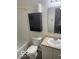 Cozy bathroom with a shower-tub combo, toilet, vanity, and wall cabinet for storage solutions at 8249 Retreat Ln, Indianapolis, IN 46259