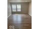 Bright bedroom with hardwood floors and natural light from the window at 8249 Retreat Ln, Indianapolis, IN 46259