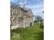 Tan home featuring a well-maintained lawn, showcasing its outdoor space at 8249 Retreat Ln, Indianapolis, IN 46259