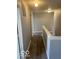 Upstairs hallway with durable wood-look flooring and neutral paint, ensuring style and easy maintenance at 8249 Retreat Ln, Indianapolis, IN 46259