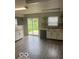 Bright kitchen featuring sliding door access to back yard, garden window, and modern appliances at 8249 Retreat Ln, Indianapolis, IN 46259