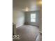 Cozy living room with neutral carpet, a window, and fresh paint at 8249 Retreat Ln, Indianapolis, IN 46259