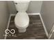 Standard white toilet with a wood-look floor creates a clean, functional bathroom at 8249 Retreat Ln, Indianapolis, IN 46259