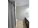 Bathroom with a wood vanity, black fixtures, and a shower with curtain at 8315 Woodall Dr, Indianapolis, IN 46268