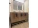 Stylish bathroom with a wood vanity, black fixtures, and a sleek, modern mirror at 8315 Woodall Dr, Indianapolis, IN 46268