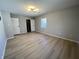 Spacious bedroom with a closet, light walls, and neutral-toned wood floors at 8315 Woodall Dr, Indianapolis, IN 46268