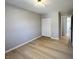Bedroom with a closet, light walls, and neutral-toned wood floors at 8315 Woodall Dr, Indianapolis, IN 46268